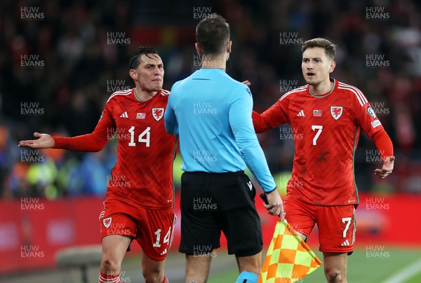 211123 - Wales v Turkey - UEFA Euro 2024 Qualifier - Connor Roberts and David Brooks of Wales question the linesman