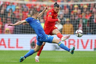 050622 -  Wales v Ukraine, World Cup Qualifying Play Off Final - Gareth Bale of Wales is challenged by Vitalii Mykolenko of Ukraine