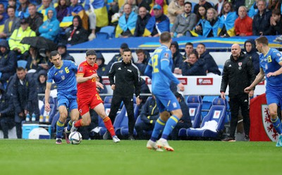 050622 -  Wales v Ukraine, World Cup Qualifying Play Off Final - Dan James of Wales is challenged by Taras Stepanenko of Ukraine as Wales manager Rob Page watches on