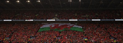 050622 -  Wales v Ukraine, World Cup Qualifying Play Off Final - A giant Welsh flag is passed up the stand ahead of the match