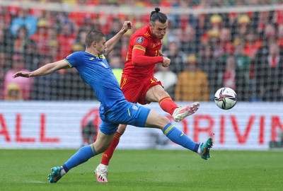 050622 -  Wales v Ukraine, World Cup Qualifying Play Off Final - Gareth Bale of Wales plays the ball past Vitalii Mykolenko of Ukraine