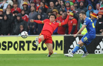 050622 -  Wales v Ukraine, World Cup Qualifying Play Off Final - Brennan Johnson of Wales looks to challenge Oleksandr Karavaev of Ukraine