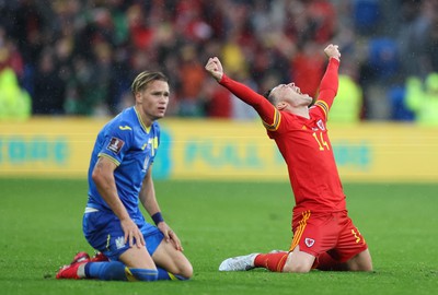 050622 -  Wales v Ukraine, World Cup Qualifying Play Off Final - Connor Roberts of Wales celebrates on the final whistle as Mykhailo Mudryk of Ukraine shows the dejection