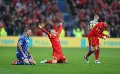 050622 -  Wales v Ukraine, World Cup Qualifying Play Off Final - Connor Roberts of Wales celebrates on the final whistle as Mykhailo Mudryk of Ukraine shows the dejection