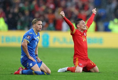 050622 -  Wales v Ukraine, World Cup Qualifying Play Off Final - Connor Roberts of Wales celebrates on the final whistle as Mykhailo Mudryk of Ukraine shows the dejection