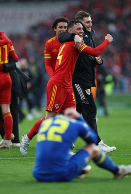 050622 -  Wales v Ukraine, World Cup Qualifying Play Off Final - Wales players celebrate as a dejected Mykola Matviyenko of Ukraine reacts with disappointment