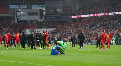 050622 -  Wales v Ukraine, World Cup Qualifying Play Off Final - Mykola Matviyenko of Ukraine in consoled by goalkeeper Georgiy Bushchan of Ukraine as Gareth Bale of Wales celebrates with Wales team mates