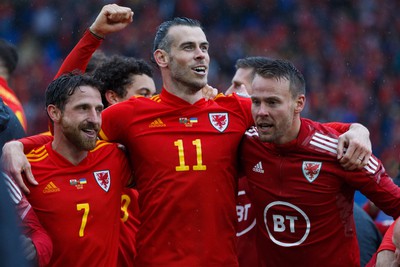 050622 -  Wales v Ukraine, World Cup Qualifying Play Off Final - Joe Allen, Gareth Bale and Aaron Ramsey of Wales celebrate at the end of the match