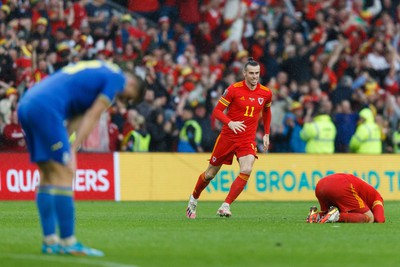 050622 -  Wales v Ukraine, World Cup Qualifying Play Off Final - Gareth Bale of Wales celebrates after the final whistle with Aaron Ramsey of Wales (on floor)