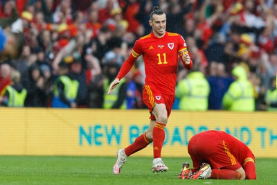 050622 -  Wales v Ukraine, World Cup Qualifying Play Off Final - Gareth Bale of Wales celebrates after the final whistle with Aaron Ramsey of Wales (on floor)