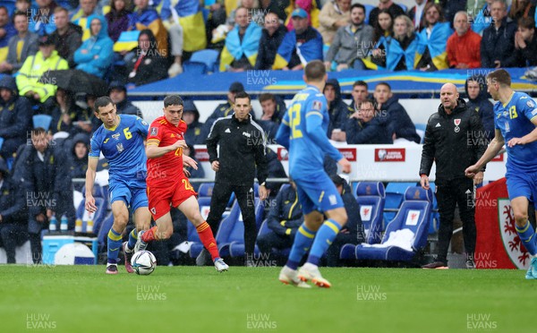 050622 -  Wales v Ukraine, World Cup Qualifying Play Off Final - Dan James of Wales is challenged by Taras Stepanenko of Ukraine as Wales manager Rob Page watches on