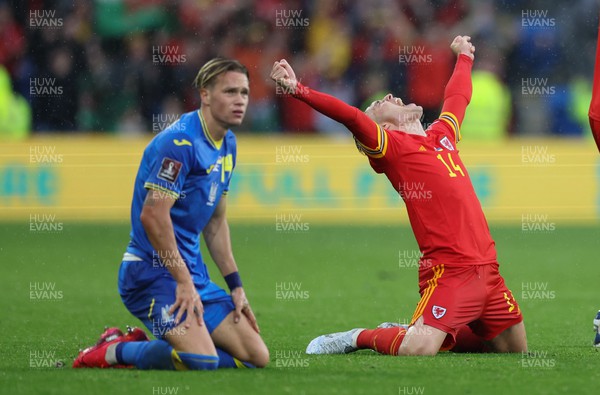 050622 -  Wales v Ukraine, World Cup Qualifying Play Off Final - Connor Roberts of Wales celebrates on the final whistle as Mykhailo Mudryk of Ukraine looks on