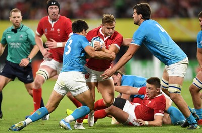 131019 - Wales v Uruguay - Rugby World Cup - Pool D - Hallam Amos of Wales is tackled by Juan Manuel Cat and Ignacio Dotti of Uruguay