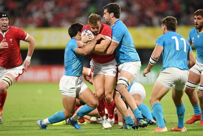 131019 - Wales v Uruguay - Rugby World Cup - Pool D - Hallam Amos of Wales is tackled by Juan Manuel Cat and Ignacio Dotti of Uruguay