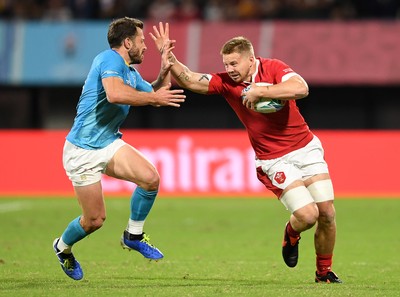 131019 - Wales v Uruguay - Rugby World Cup - Pool D - James Davies of Wales is tackled by Felipe Berchesi of Uruguay