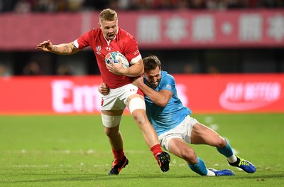 131019 - Wales v Uruguay - Rugby World Cup - Pool D - James Davies of Wales is tackled by Felipe Berchesi of Uruguay