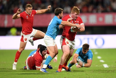 131019 - Wales v Uruguay - Rugby World Cup - Pool D - Rhys Carre of Wales is tackled by Felipe Berchesi and Leandro Leivas of Uruguay