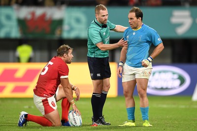 131019 - Wales v Uruguay - Rugby World Cup - Pool D - Leigh Halfpenny of Wales and Juan Manuel Gaminara of Uruguay with Referee Angus Gardner at full time