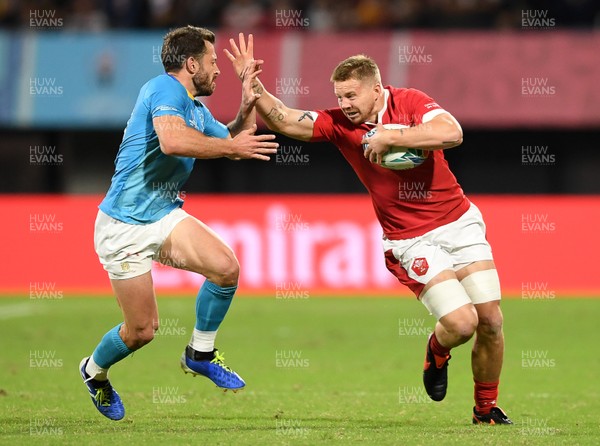 131019 - Wales v Uruguay - Rugby World Cup - Pool D - James Davies of Wales is tackled by Felipe Berchesi of Uruguay