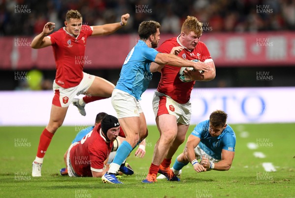 131019 - Wales v Uruguay - Rugby World Cup - Pool D - Rhys Carre of Wales is tackled by Felipe Berchesi and Leandro Leivas of Uruguay
