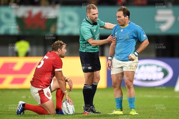 131019 - Wales v Uruguay - Rugby World Cup - Pool D - Leigh Halfpenny of Wales and Juan Manuel Gaminara of Uruguay with Referee Angus Gardner at full time