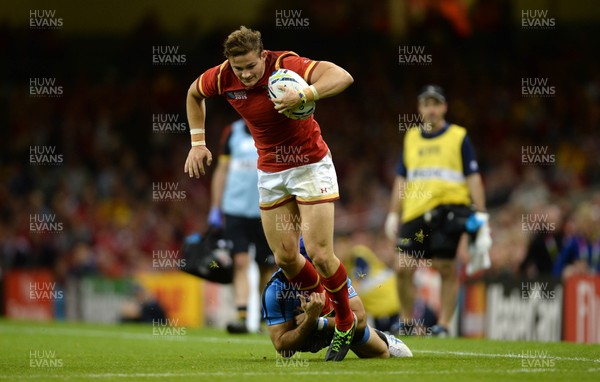 200915 - Wales v Uruguay - Rugby World Cup 2015 -Hallam Amos of Wales is tackled by Francisco Bulanti of Uruguay