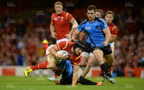 200915 - Wales v Uruguay - Rugby World Cup 2015 -James King of Wales is tackled by Joaquin Prada of Uruguay