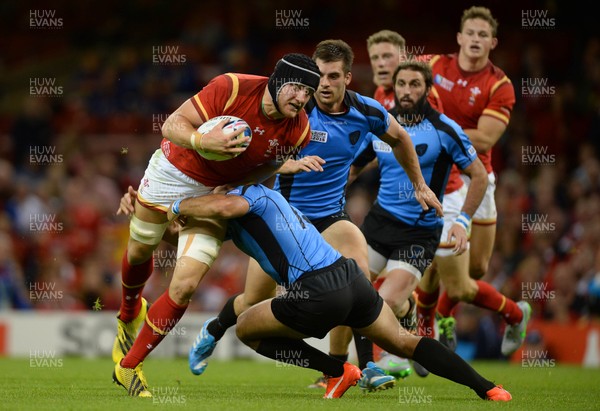 200915 - Wales v Uruguay - Rugby World Cup 2015 -James King of Wales is tackled by Joaquin Prada of Uruguay