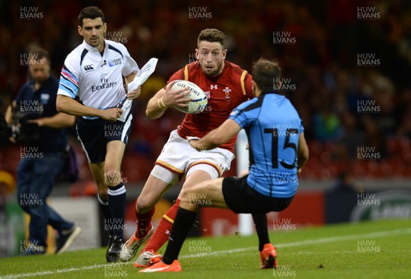 200915 - Wales v Uruguay - Rugby World Cup 2015 -Alex Cuthbert of Wales is tackle by Gaston Mieres of Uruguay