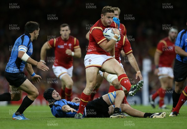 200915 - Wales v Uruguay - Rugby World Cup 2015 - Hallam Amos of Wales charges past Matias Beer of Uruguay