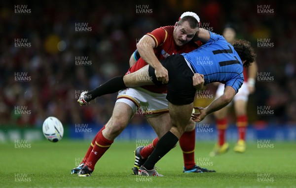 200915 - Wales v Uruguay - Rugby World Cup 2015 - Ken Owens of Wales tackles Rodrigo Silva of Uruguay