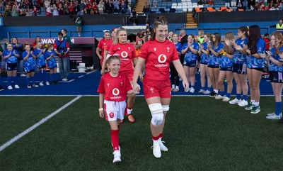 260926 Wales v USA, Vodafone Wales WXV Series - Kate Williams of Wales with the mascot at the team take to the pitch