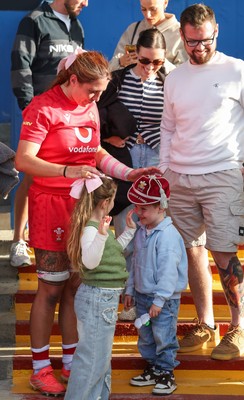 260926 Wales v USA, Vodafone Wales WXV Series - Georgia Evans of Wales with niece Ella-May and nephew Noah and her 50 cap at the end of the match