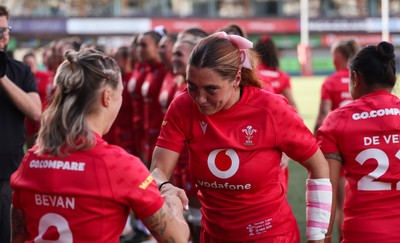 260926 Wales v USA, Vodafone Wales WXV Series - Georgia Evans of Wales greets her team mates as they walk out at the start of the match