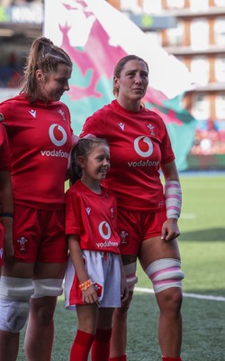 260926 Wales v USA, Vodafone Wales WXV Series - Georgia Evans of Wales and Kate Williams of Wales with the match mascot during the anthems