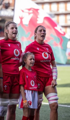 260926 Wales v USA, Vodafone Wales WXV Series - Georgia Evans of Wales and Kate Williams of Wales with the match mascot during the anthems