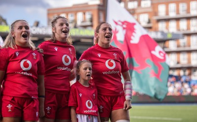 260926 Wales v USA, Vodafone Wales WXV Series - Alex Callender of Wales, Kate Williams of Wales and Georgia Evans of Wales with the match mascot during the anthems