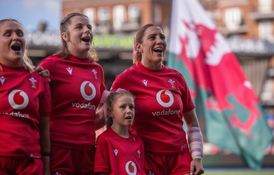 260926 Wales v USA, Vodafone Wales WXV Series - Alex Callender of Wales, Kate Williams of Wales and Georgia Evans of Wales with the match mascot during the anthems