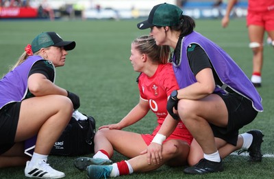 260926 Wales v USA, Vodafone Wales WXV Series - Amy Williams of Wales is checked by Erin Lynch, Wales National Squad Physio and Gwennan Williams, Team Doctor
