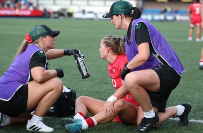 260926 Wales v USA, Vodafone Wales WXV Series - Amy Williams of Wales is checked by Erin Lynch, Wales National Squad Physio and Gwennan Williams, Team Doctor