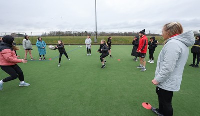 080323 - Wales Women 6 Nations Squad Announcement, Ysgol Dyffryn Aman, Ammanford - Wales Women players Hannah Jones and Ffion Lewis return to their former school and take a girls rugby skills session after the girls helped to formally announce the Wales Women’s squad for the forthcoming Women’s 6 Nations