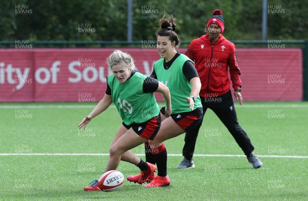 230521 - Wales Women 7s Squad Training - Alex Callender and Shona Powell-Hughes are watched by head coach Warren Abrahams during training session