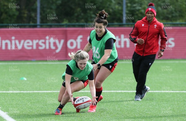 230521 - Wales Women 7s Squad Training - Alex Callender and Shona Powell-Hughes are watched by head coach Warren Abrahams during training session
