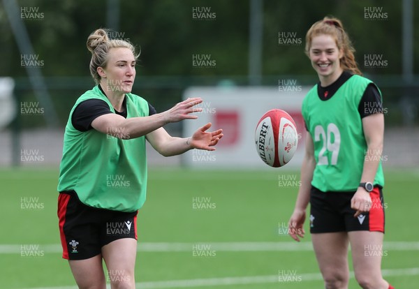 230521 - Wales Women 7s Squad Training - Beth Dainton passes as Lisa Neumann looks on during training session