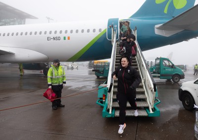 110424 - Wales Women Rugby Travel to Ireland - Abbey Constable disembarks the plane at a wet and windy Cork airport ahead of Wales’ Women’s 6 Nations match against Ireland