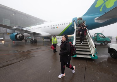 110424 - Wales Women Rugby Travel to Ireland - Abbey Constable disembarks the plane at a wet and windy Cork airport ahead of Wales’ Women’s 6 Nations match against Ireland