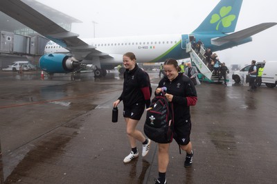 110424 - Wales Women Rugby Travel to Ireland - Carys Cox and Lleucu George disembark the plane at a wet and windy Cork airport ahead of Wales’ Women’s 6 Nations match against Ireland