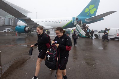 110424 - Wales Women Rugby Travel to Ireland - Carys Cox and Lleucu George disembark the plane at a wet and windy Cork airport ahead of Wales’ Women’s 6 Nations match against Ireland