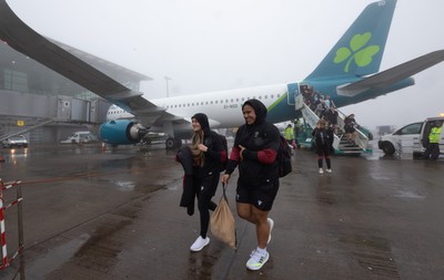 110424 - Wales Women Rugby Travel to Ireland - Hannah Jones and Sisilia Tuipulotu disembark the plane at a wet and windy Cork airport ahead of Wales’ Women’s 6 Nations match against Ireland