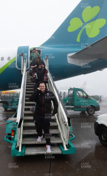 110424 - Wales Women Rugby Travel to Ireland - Abbey Constable disembarks the plane at a wet and windy Cork airport ahead of Wales’ Women’s 6 Nations match against Ireland